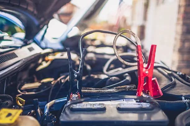 Jump-start cables connected to a vehicle battery