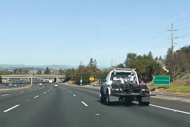 Long-distance tow truck travelling on an open road