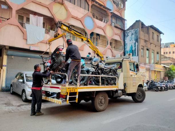 Motorcycles being loaded onto a dedicated recovery truck